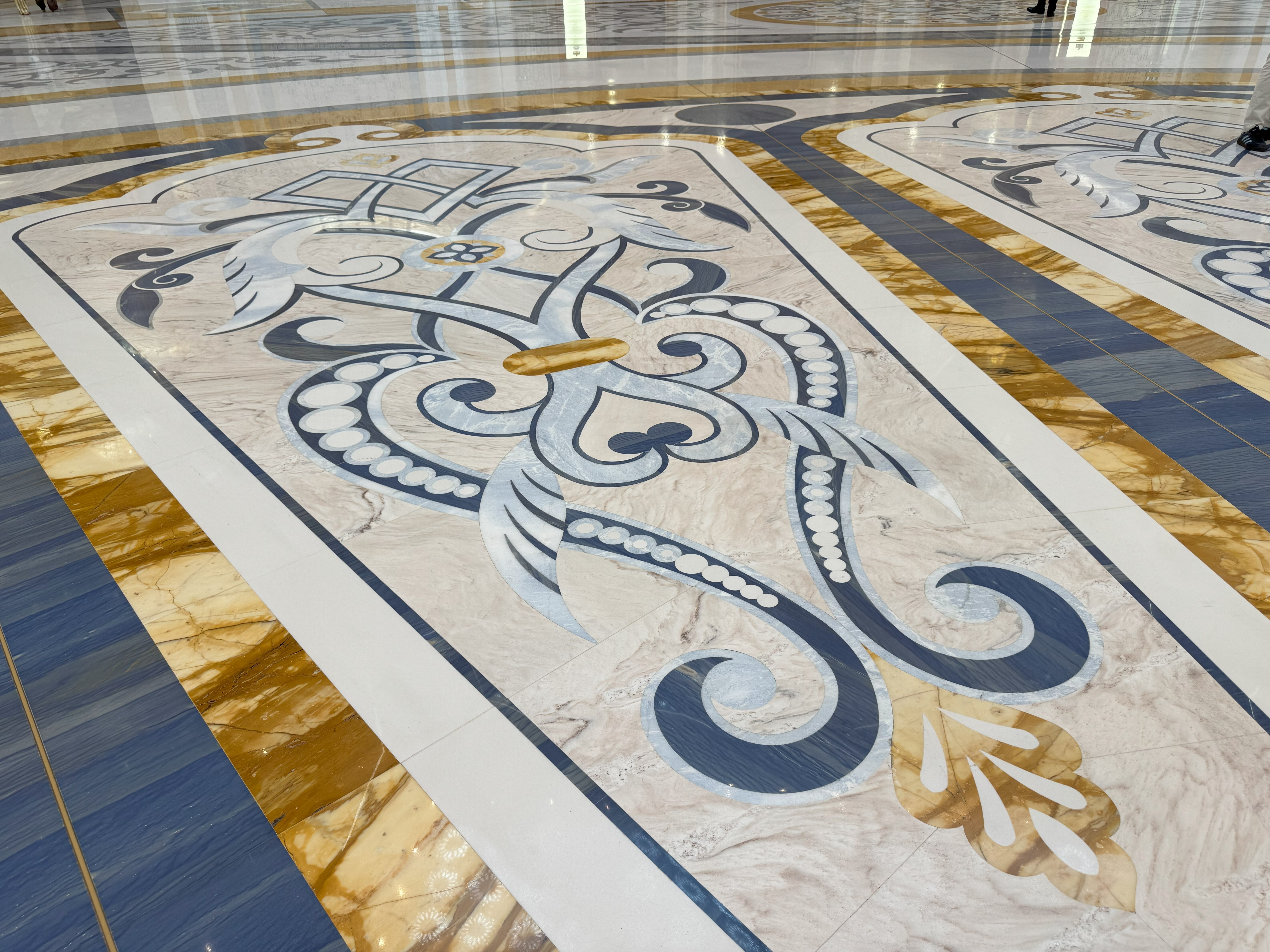 The intricate details on the marble floor inside the Qasr Al Watan